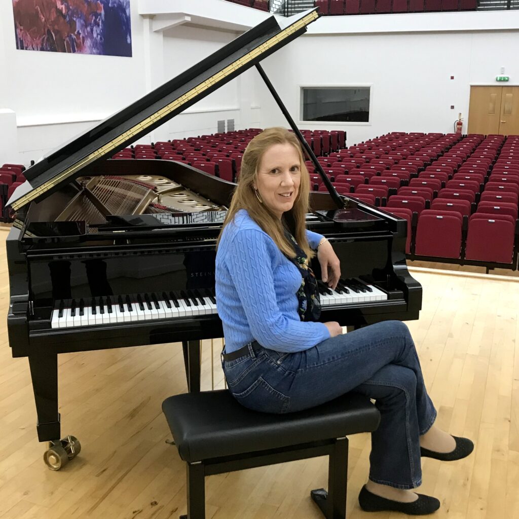 Sarah Beth Briggs seated at piano